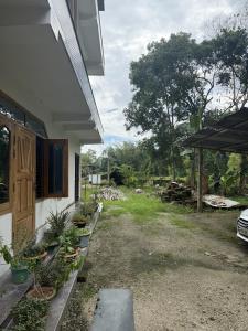 a side view of a house with a yard at The Family Haven Homestay in Golāghāt