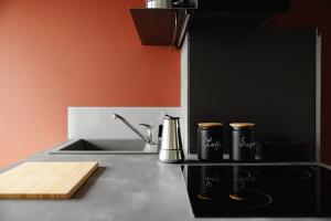 a kitchen counter with a sink and two coffee mugs at Donizetti Studios in Bergamo