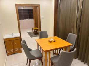 a dining room with a table and chairs and a bathroom at Vilstay Premium- Fathima 2BHK in Kottakkal