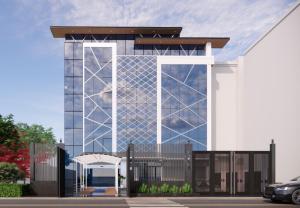 a large glass building with a fence in front of it at Abharam Retreats in Ghaziabad