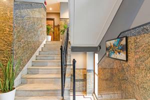 a staircase in a house with a painting on the wall at FabHotel Gulshan International - Nr Peter Cat Park Street in Kolkata