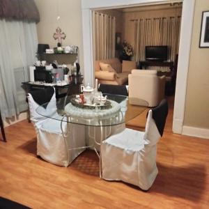 a living room with a glass table and chairs at Restful 2 in Ruston