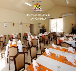 a banquet hall with white tables and chairs at شاليه بقريه روجينا العين السخنه in Ain Sokhna