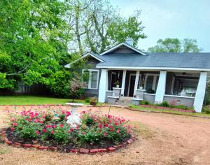a house with a flower bed in front of it at Restful 2 in Ruston