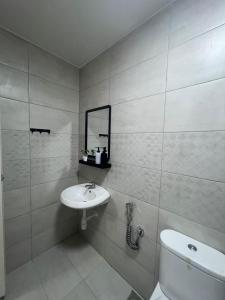 a bathroom with a sink and a toilet and a mirror at Sky28 - Sireh Residence in Kota Bharu +20 photos
