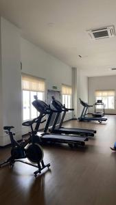 a gym with three exercise bikes in a room at Sky28 - Sireh Residence in Kota Bharu