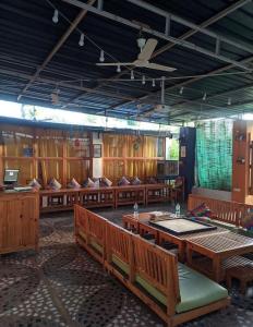 a large room with wooden tables and benches at Moondance Hostel & Garden Restaurant in Pushkar +57 photos