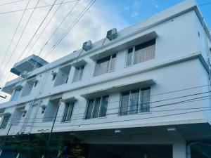 a white building with windows on the side of it at AHLAN (BED & BREAKFAST) in Port Blair