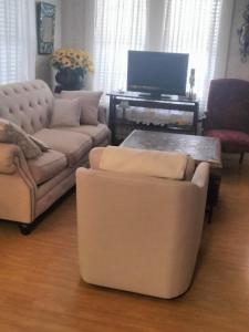 a living room with two couches and a tv at Nonies in Ruston