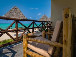 a view of the beach from a resort with chairs and umbrellas at Mahi Mahi Beach Hotel in Jambiani