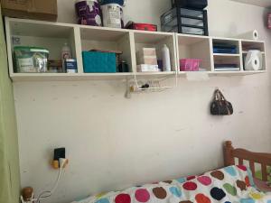 a bedroom with white shelves and a bed at Mistral Bobigny in Bobigny