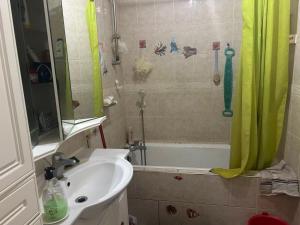 a bathroom with a sink and a bath tub at Mistral Bobigny in Bobigny
