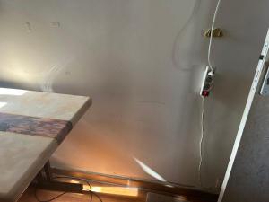 a room with a table and a wall with a cord at Mistral Bobigny in Bobigny +3 photos
