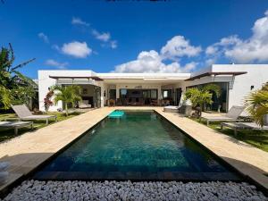 a house with a swimming pool in front of it at Zolikaz in Grand-Baie
