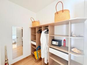 a dressing room with white shelves and a mirror at Zolikaz in Grand-Baie +13 photos