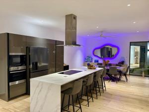 a kitchen with a large island with bar stools at Zolikaz in Grand-Baie