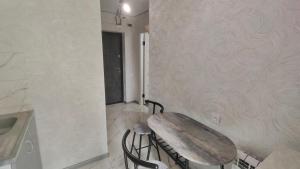 a kitchen with a table and chairs in a room at Квартира в центре in Mykolaiv