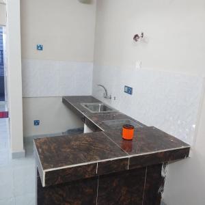 a kitchen with a sink and a counter top at Best Eastern, Nikunja-2 in Dhaka
