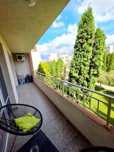 a balcony with a table and a tree at Summer Dream, Nesebar Fort Club, Sunny Beach in Sunny Beach