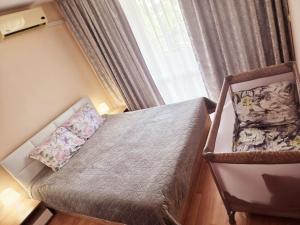 a small bedroom with a bed and a window at Summer Dream, Nesebar Fort Club, Sunny Beach in Sunny Beach