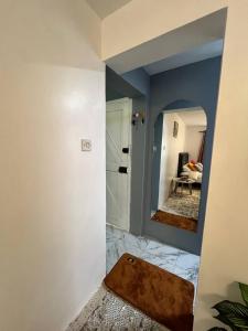 a bathroom with a mirror and a room at Kileleshwa studio in Nairobi +1 photo