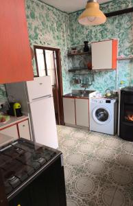 a kitchen with a refrigerator and a washing machine at Ca' della Sfinge Colibrì a Civiasco in Varallo