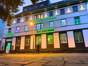 a building with a sign on the front of it at Wohnen inklusive Fitness & Wellness in Dessau