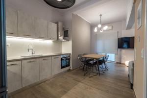 a kitchen and dining room with a table and chairs at Luxury Serenity in Piraeus