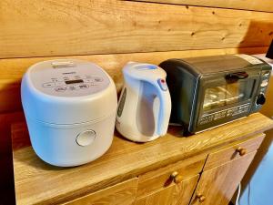a counter with a toaster and a microwave on it at Secret Base Mysa シークレットベース ミーサ 星の街399 in Tsumagoi