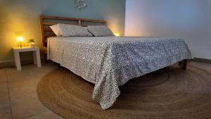 a bedroom with a bed with a blanket on it at Countryside home Villa Luna with Private Yard & Jacuzzi in Alora