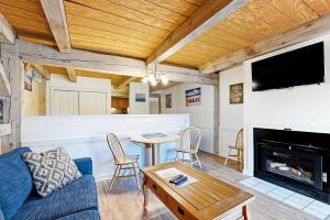 a living room with a couch and a table and a fireplace at Island Inn in Oak Bluffs