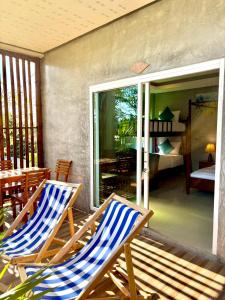 two chairs sitting on the porch of a house at Lanta Just Come Resort in Ko Lanta Yai