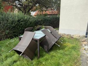 a table and chairs sitting in the grass at Großzügige Ferienwohnung in Fleischwangen - Platz bis zu 8 Personen in Fleischwangen