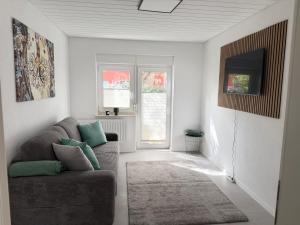 a living room with a couch and a tv at Großzügige Ferienwohnung in Fleischwangen - Platz bis zu 8 Personen in Fleischwangen