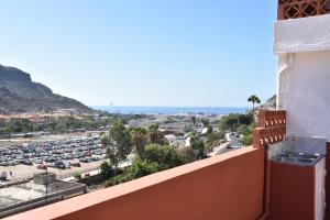 a view of a city from the balcony of a building at Apartamento Vero in Puerto de Mogán