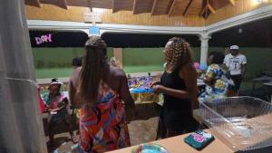 two women standing in a room with a party at Eve's Rockaway Villa in Alligator Pond Village +105 photos