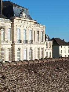 a large building with a clock on top of it at D OR et D ARGENT in Arceau