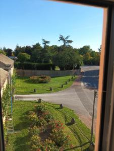 a view from a window of a garden with flowers at D OR et D ARGENT in Arceau +3 photos