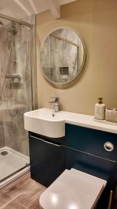 a bathroom with a sink and a shower at Kil Margh - Rising Sun Inn in Altarnun