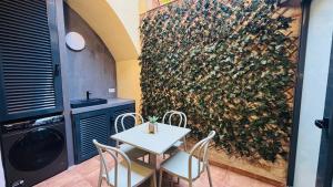 a table and chairs in a kitchen with a wall at Bajos con encanto by Prestigi in Terrassa
