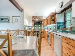 a large kitchen with wooden cabinets and a counter top at Berwyn Bank in Gilcrux
