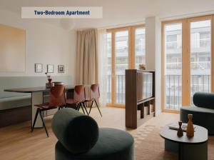 a living room with a table and chairs at Edgar Suites Hameau - Porte de Versailles in Paris