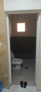 a bathroom with a toilet and a window at شقة بروق شهري in Quai