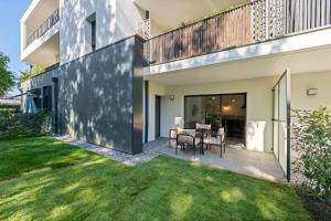 an external view of a house with a patio and grass at Le Cocon du Leman in Thonon-les-Bains