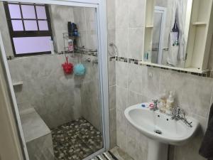 a bathroom with a shower and a sink at Sea Cottage 49 in Mossel Bay