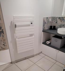 a white bathroom with a sink and a toilet at Le Moulin des Puys in Orcines +19 photos