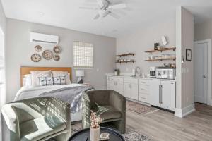 a bedroom with a bed and a chair and a kitchen at Sleek City Studio Escape in Durham