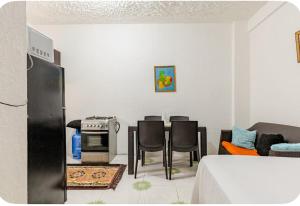 a room with a kitchen with a table and chairs at Tamara In in Ocho Rios +10 photos