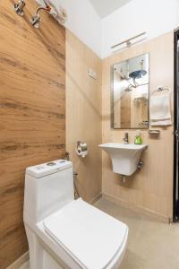 a bathroom with a white toilet and a sink at Homlee-Luxury Inn 3BHK in New Delhi +20 photos