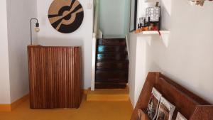 a hallway with a wooden radiator next to a staircase at NOMAD Hostel Stone Town in Zanzibar City